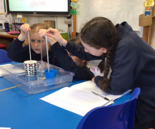 Three children using thermometers 